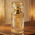 Oud Perfume bottle with gold accents on a wooden surface
